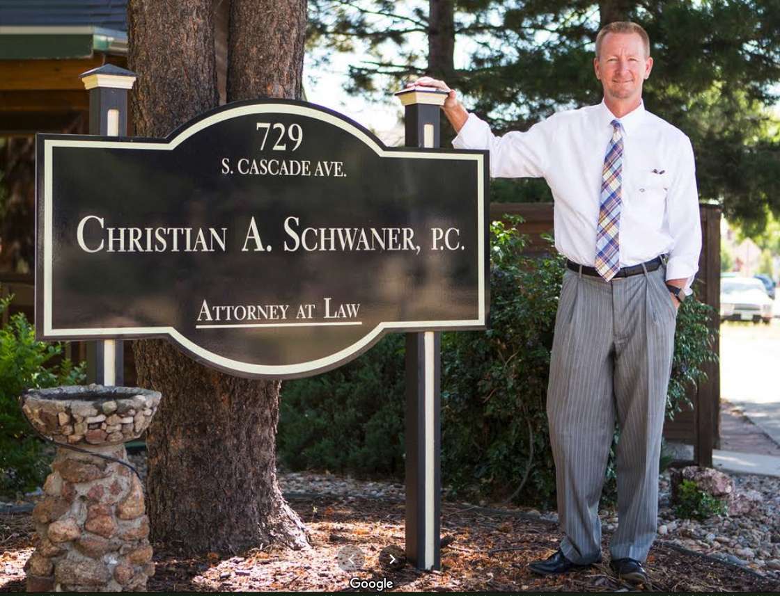 Attorney Christian A. Schwaner standing by his sign.