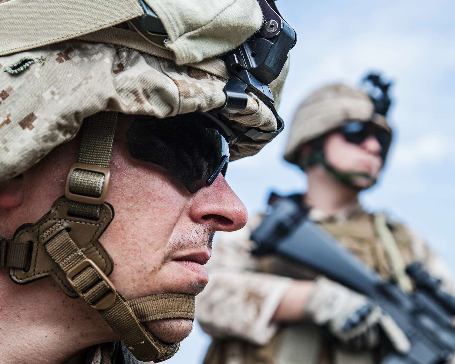 Close-up of soldiers in tactical gear outdoors.