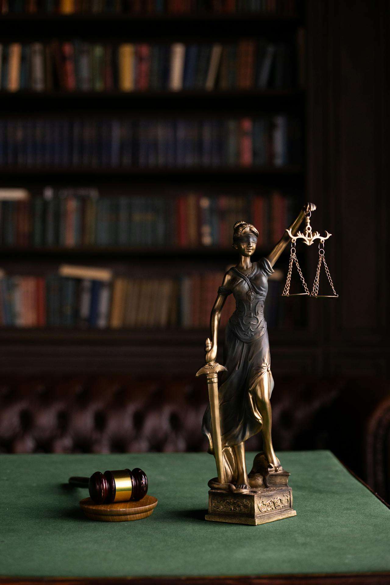 Justice statue and gavel in a law library.
