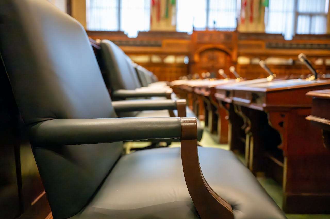 Rows of empty leather chairs in a legislative chamber