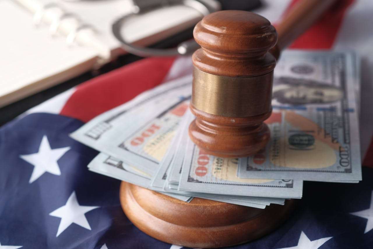 Gavel on cash atop an American flag