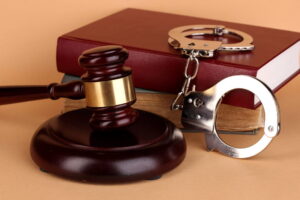 Gavel, handcuffs, and books symbolizing law and justice.